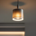 A photograph of a stylishly designed cylinder light fixture installed in a modern interior setting