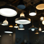 A photograph of a dimly lit room showcasing a variety of ceiling lights