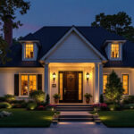 A photograph of a beautifully illuminated exterior of a house at dusk