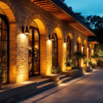 A photograph of a beautifully illuminated outdoor space featuring various styles of exterior lighting fixtures in use