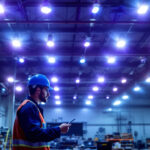 A photograph of a well-lit industrial workspace featuring high bay led shop lights in action