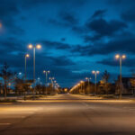 A photograph of a well-lit parking lot at dusk