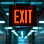 A photograph of a well-lit exit sign in a commercial building