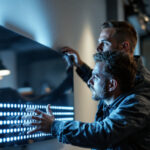 A photograph of a lighting contractor installing or showcasing a sleek