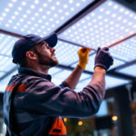 A photograph of a lighting contractor expertly installing led panels in a modern commercial space