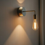 A photograph of a stylish sconce light fixture installed on a well-decorated wall