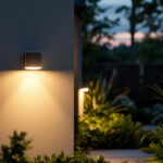 A photograph of capture a photograph of a modern outdoor sensor light illuminating a beautifully landscaped garden at dusk