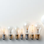 A photograph of a variety of light bulb bases displayed together on a clean