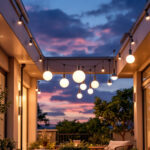 A photograph of a stylish outdoor space featuring modern exterior ceiling lights in use