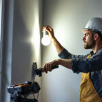 A photograph of capture a photograph of a lighting contractor installing wall led lights in a modern interior space