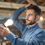 A photograph of a lighting contractor in action