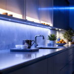 A photograph of a beautifully illuminated kitchen with sleek led under-counter lights highlighting the cabinetry and workspace