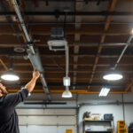 A photograph of a well-lit garage interior showcasing various ceiling light fixtures in use