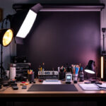 A photograph of a well-organized lighting workspace featuring essential tools and equipment