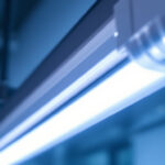 A photograph of a close-up shot of a fluorescent tube light in a well-lit environment