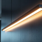 A photograph of a modern linear light fixture installed in a stylish interior setting