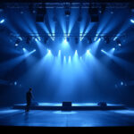 A photograph of a well-lit theater stage showcasing various lighting fixtures in action