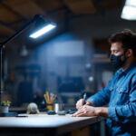 A photograph of a well-lit workshop or garage scene featuring a 48 led 5000 kelvin shop light in action