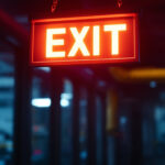 A photograph of a well-lit exit sign in a commercial or industrial setting