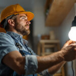 A photograph of a lighting contractor at work