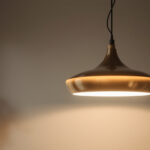 A photograph of a beautifully designed large pendant light hanging in a stylish interior setting