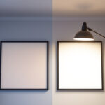 A photograph of a side-by-side comparison of a lit led diffuser panel and a traditional lighting fixture in a well-lit room