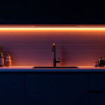 A photograph of a modern kitchen with stylish under-cabinet led lights illuminating the countertop