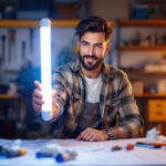 A photograph of a lighting contractor showcasing a vibrant fluorescent led lamp in a well-lit workspace