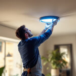A photograph of a skilled lighting contractor installing a sleek