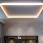 A photograph of a modern ceiling recessed light installation in a stylish interior setting