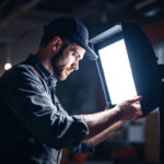A photograph of a lighting contractor in action