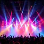 A photograph of a dynamic concert scene featuring a variety of professional lighting equipment in action