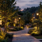 A photograph of a beautifully illuminated outdoor space featuring various styles of post lighting