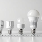 A photograph of a well-organized display of various light bulb bases and sockets