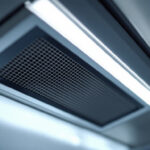 A photograph of a close-up view of a fluorescent light grate louver installed in a commercial setting