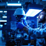 A photograph of a lighting contractor efficiently installing an ultraviolet lamp in a commercial setting