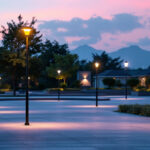 A photograph of a well-lit outdoor space featuring various styles of pole lights in use