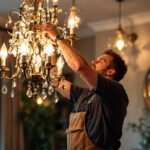 A photograph of a beautifully designed chandelier illuminated in a stylish interior setting