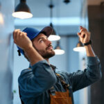 A photograph of a lighting contractor in action