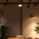 A photograph of a stylish interior space showcasing various types of track lighting in use