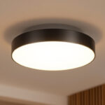 A photograph of a stylish modern flush mount light fixture installed in a contemporary interior setting