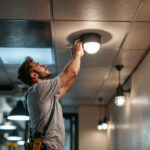 A photograph of a lighting contractor installing modern