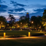 A photograph of a beautifully illuminated park at dusk