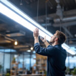 A photograph of a modern led fluorescent light fixture installed in a well-lit commercial space