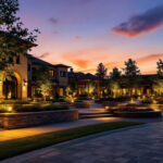 A photograph of a beautifully illuminated commercial landscape at dusk