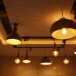 A photograph of a stylishly designed ceiling with various modern lighting fixtures