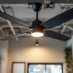 A photograph of a stylish industrial ceiling fan installed in a well-lit commercial space
