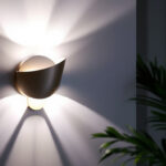 A photograph of a beautifully designed wall sconce illuminated in a stylish interior setting