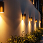 A photograph of a beautifully illuminated outdoor space featuring stylish wall lights