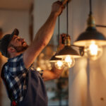 A photograph of a lighting contractor skillfully installing stylish barn light company fixtures in a beautifully lit residential or commercial space